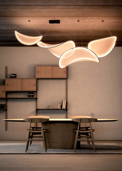 llll.09 modular lighting suspended horizontally above a dining table, creating a floating cloud-like composition with soft ambient illumination and sculptural architectural presence.