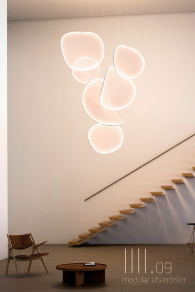 Six sculptural light elements forming a 300 cm vertical column with a warm, diffused glow.
